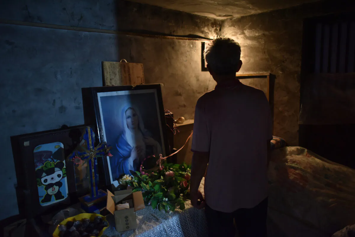 A man stands in a room in a house church in Puyang, in China's central Henan Province on Aug. 13, 2018. (Greg Baker/AFP via Getty Images)