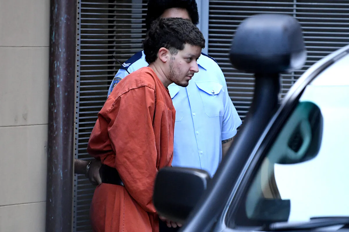 Mert Ney is led to a Corrective Services transport vehicle at the NSW Supreme Court in Sydney, Tuesday, March 30, 2021. (AAP Image/Dan Himbrechts)