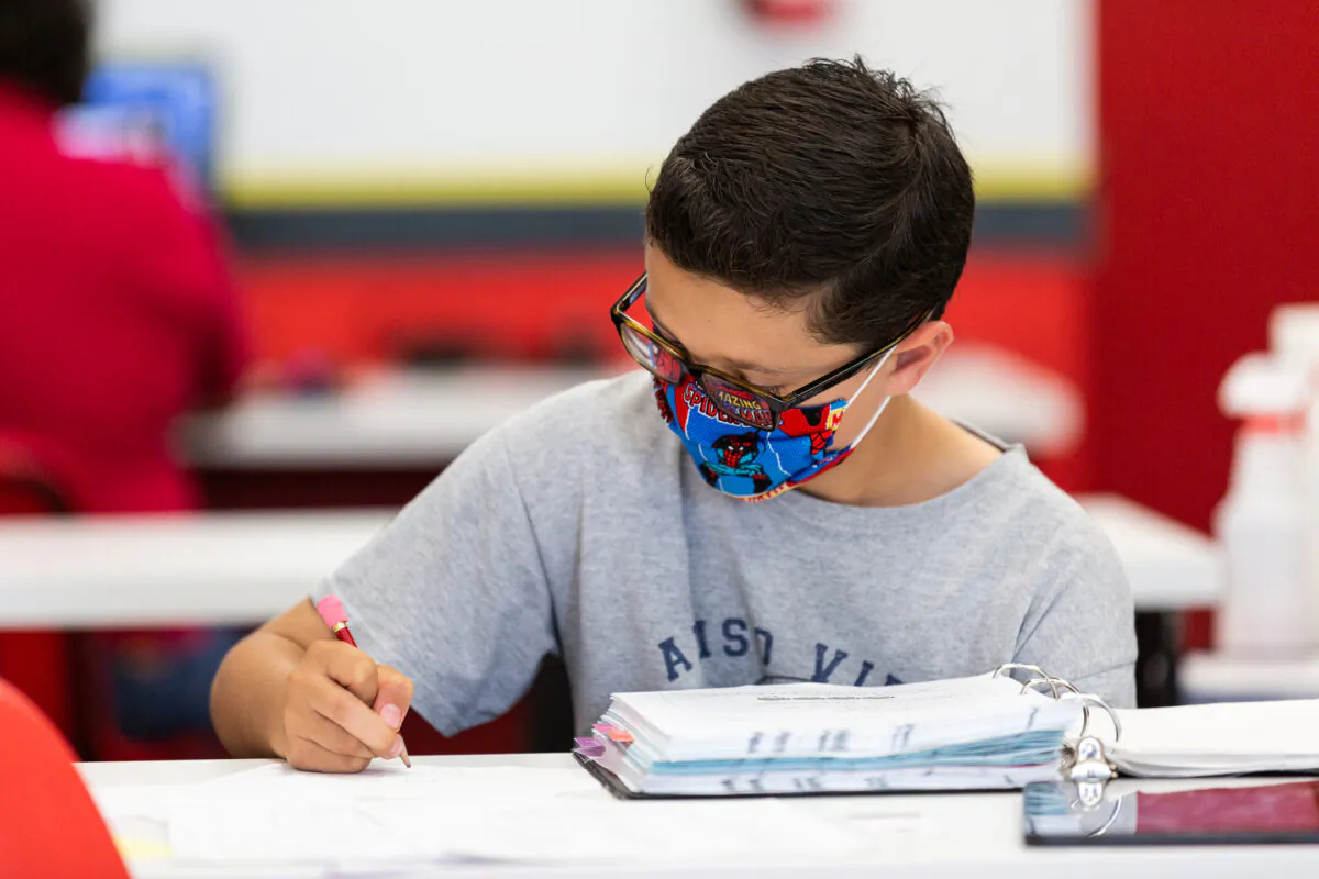 Student Nikolas Hoaen performs a math assignment at Mathnasium, in Laguna Niguel, Calif., on May 12, 2021. (John Fredricks/The Epoch Times)