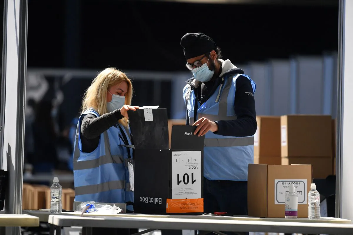 Staff open a ballot box to count for the local elections at the count centre at Olympia London in west London on May 7, 2021. (Justin Tallis/AFP via Getty Images)