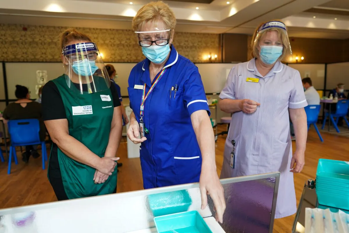 Medical staff wait for Pfizer-BioNTech COVID-19 vaccines to be drawn up at the Hexham Mart Vaccination Centre in Hexham, England, on May 13, 2021. (Ian Forsyth/Getty Images)