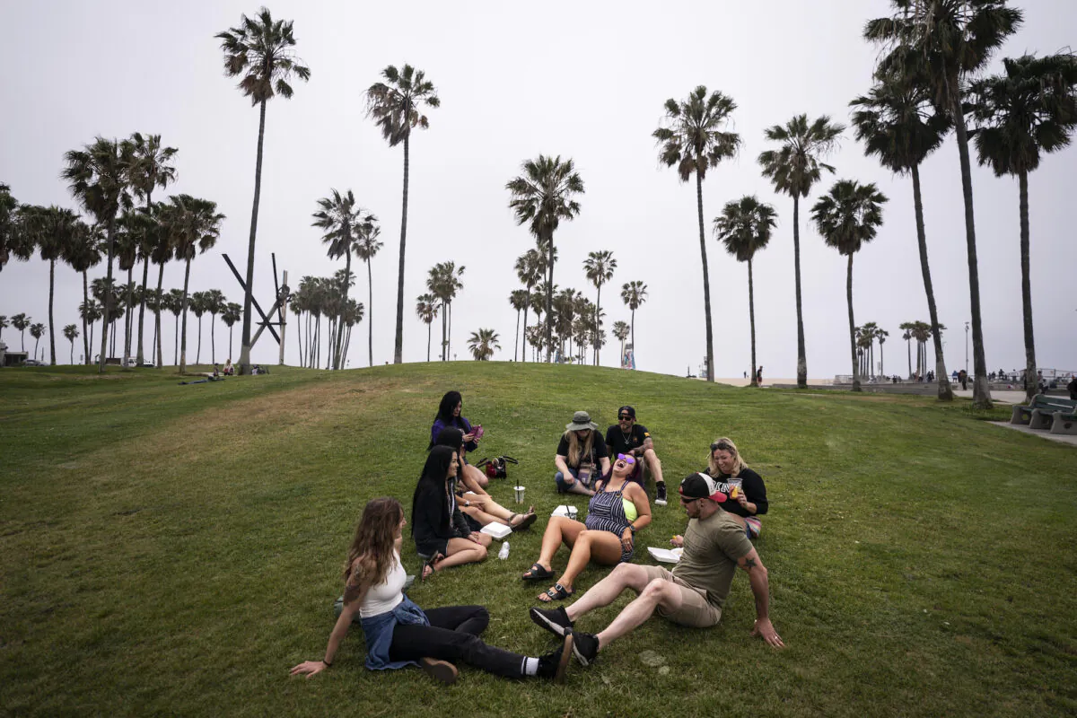 A group of friends, who said they are fully vaccinated for COVID-19, mingle on the beach in Los Angeles, Calif., on May 5, 2021. (Jae C. Hong/AP Photo)