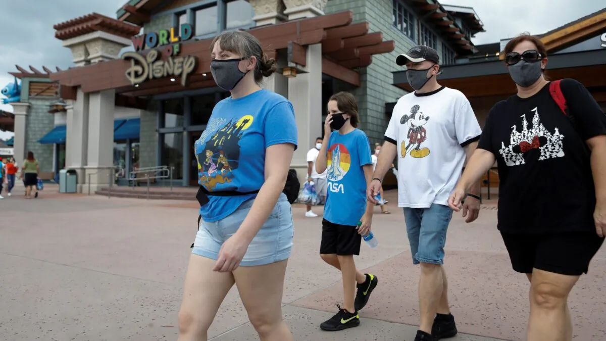 Summer Selmon, her brother Levi, and their parents Dave and Brandi wear masks while visiting the Disney Springs shopping and dining district during their vacation at Walt Disney World during a phased reopening from coronavirus disease restrictions in Lake Buena Vista, Fla., on July 11, 2020. (Octavio Jones/Reuters)