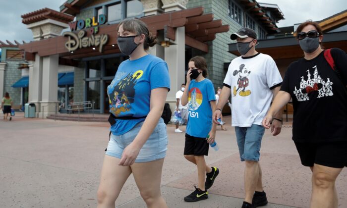 Summer Selmon, her brother Levi, and their parents Dave and Brandi wear masks while visiting the Disney Springs shopping and dining district during their vacation at Walt Disney World during a phased reopening from coronavirus disease  restrictions in Lake Buena Vista, Fla., on July 11, 2020. (Octavio Jones/Reuters)