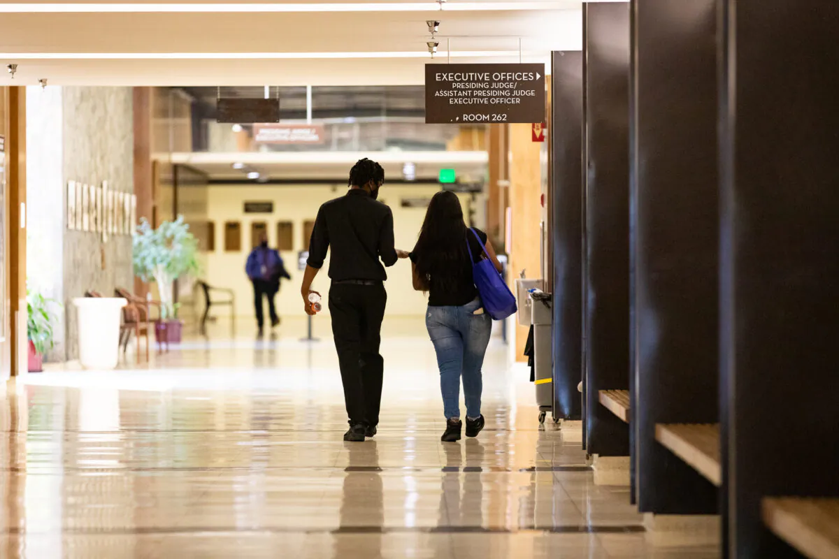 People walk through the Orange County Central Justice Center, in Santa Ana, Calif., on Sept. 18, 2020. (John Fredricks/The Epoch Times)