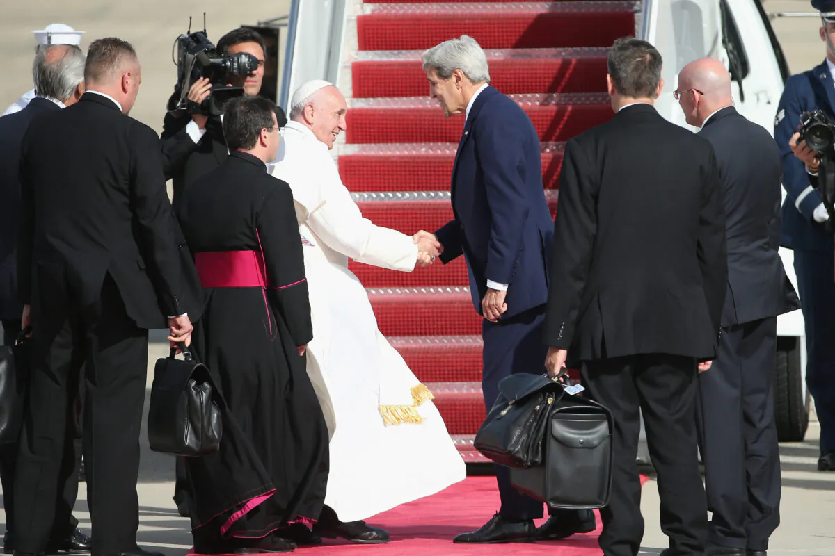 Pope Francis bids farewell to then-Secretary of State John Kerry as he departs from Washington en route to New York City in Joint Base Andrews, Maryland on Sept. 24, 2015. (Patrick Smith/Getty Images)