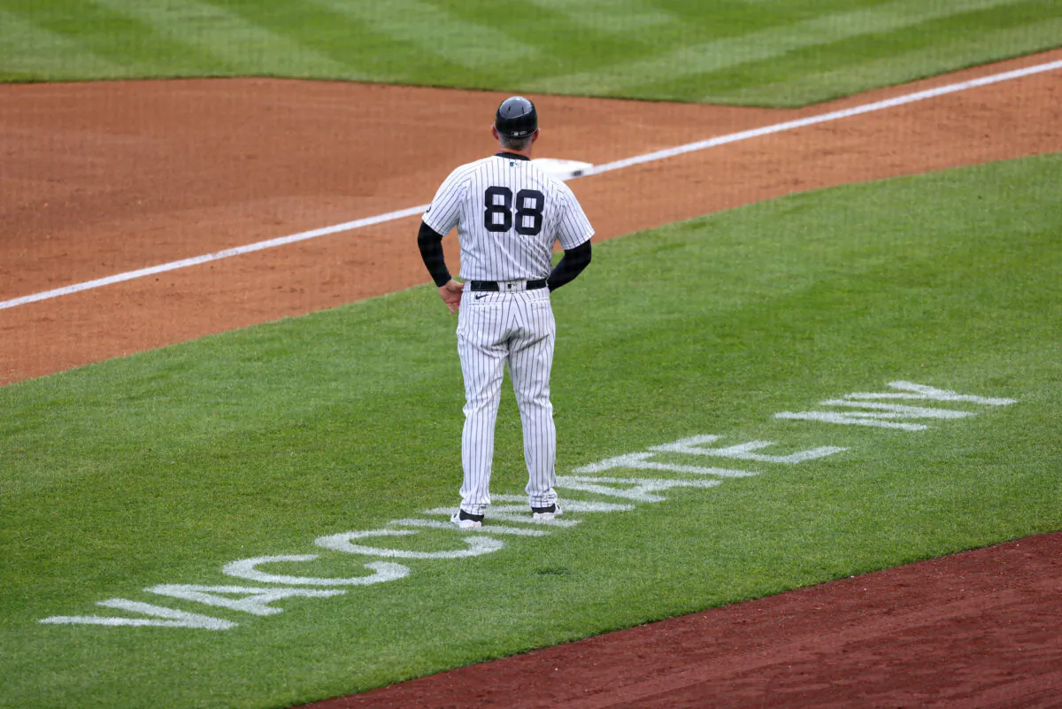 Third base coach Phil Nevin #88 of the New York Yankees stands near the coaching box as Vaccinate NY is painted on the field during a game against the Washington Nationals at Yankee Stadium in New York City on May 8, 2021. Nevin was among members of the New York Yankees who have tested positive for COVID-19. (Rich Schultz/Getty Images)