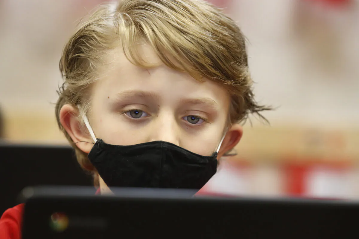 A student wears a mask as he does his work at Freedom Preparatory Academy in Provo, Utah, on Feb. 10, 2021. (George Frey/Getty Images)