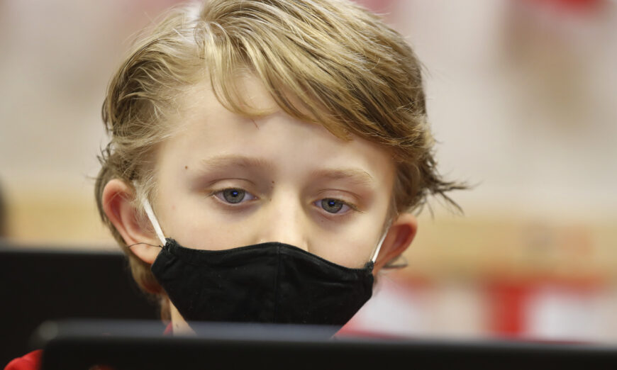 A student wears a mask as he does his work at Freedom Preparatory Academy in Provo, Utah, on Feb. 10, 2021. (George Frey/Getty Images)