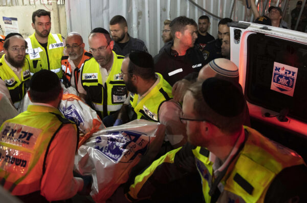 Israeli rescue workers carry a body