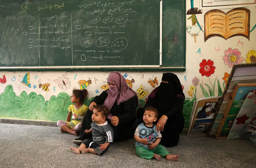 Palestinian women and children take shelter at a United Nations school in Rafah in the southern Gaza Strip on May 17, 2021. (Said Khatib/AFP via Getty Images)