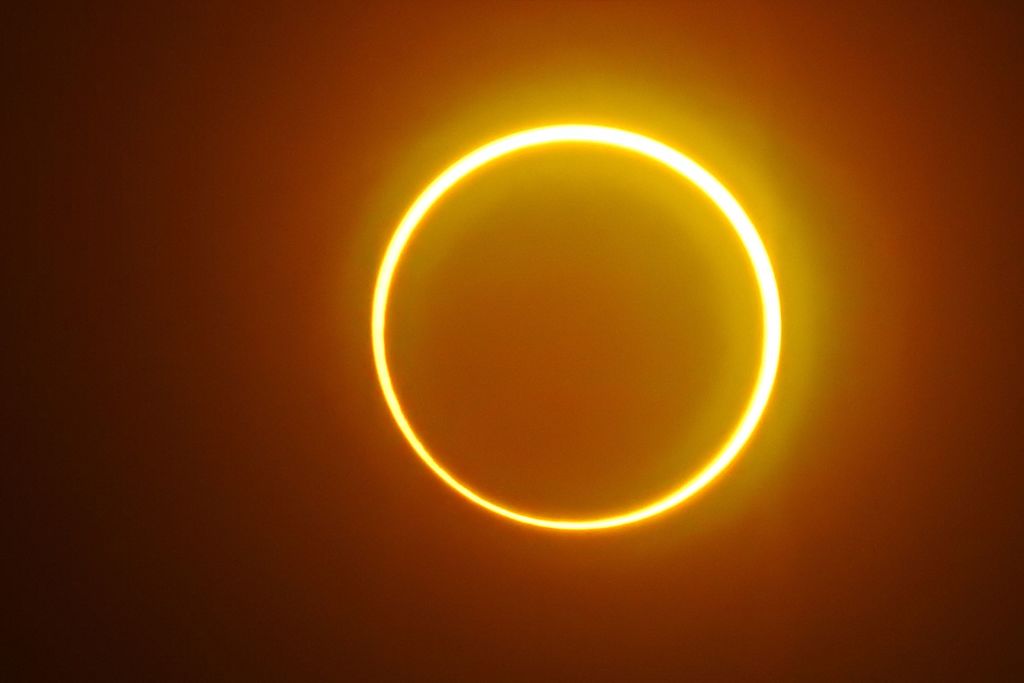 TOPSHOT - The moon moves in front of the sun in a rare "ring of fire" solar eclipse as seen from Balut Island, Saraggani province in the southern island of Mindanao on December 26, 2019. (Photo by Ferdinandh CABRERA / AFP) (Photo by FERDINANDH CABRERA/AFP via Getty Images)