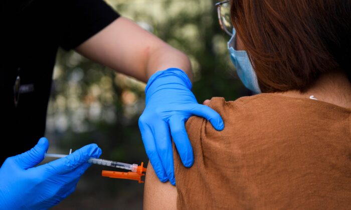 A 15-year-old receives a COVID-19 vaccine at a mobile vaccination clinic at the Weingart East Los Angeles YMCA in Los Angeles, Calif., on May 14, 2021. (Patrick T. Fallon/AFP via Getty Images)