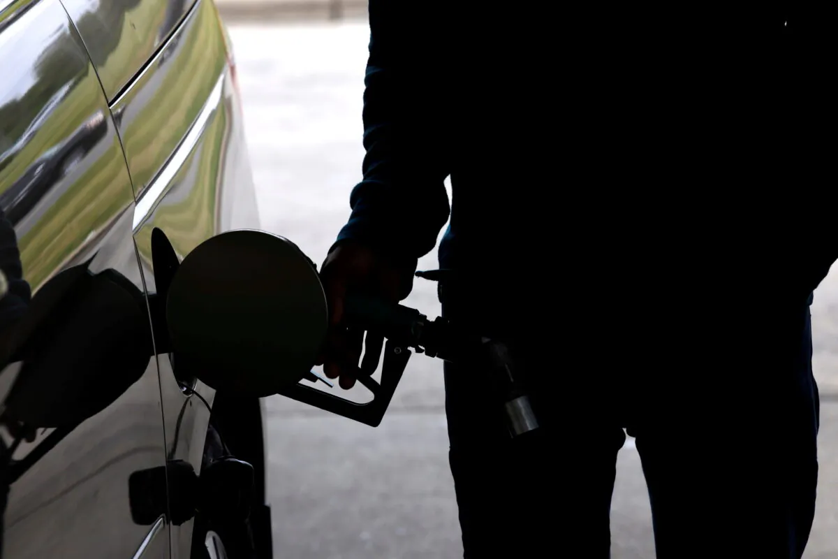 A motorist tops up the fuel in his car's gas tank in Durham, N.C., on May 12, 2021. (Jonathan Drake/Reuters)