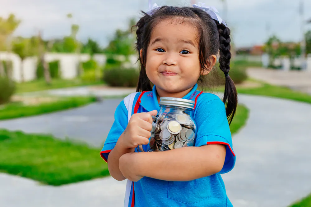 Instilling the savings habit in kids from a young age is a great start to their financial education. (NARONGRIT LOKOOLPRAKIT/Shutterstock)
