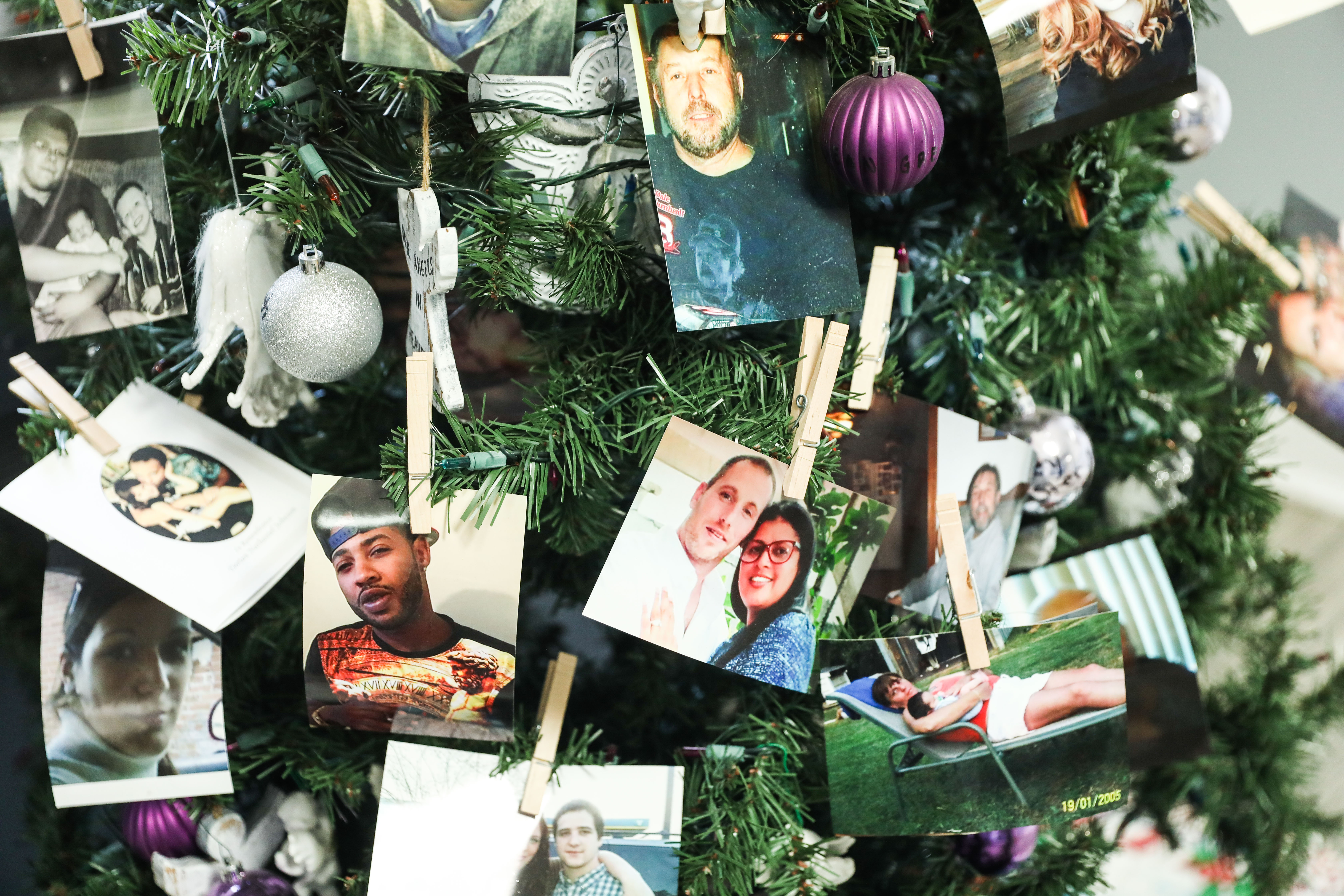 Photos of people who have died due to their opioid addiction, on a tree at The McShin Foundation, a nonprofit recovery community organization, in Richmond, Va., on May 12, 2021. (Samira Bouaou/The Epoch Times)