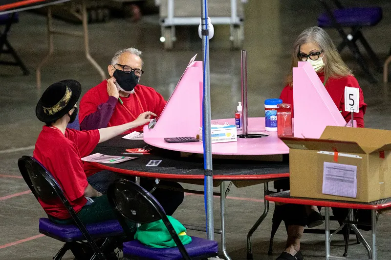 Contractors working for Cyber Ninjas, which was hired by the Arizona state Senate, examine and recount ballots from the 2020 general election at Veterans Memorial Coliseum in Phoenix, Ariz., on May 1, 2021. (Courtney Pedroza/Getty Images)