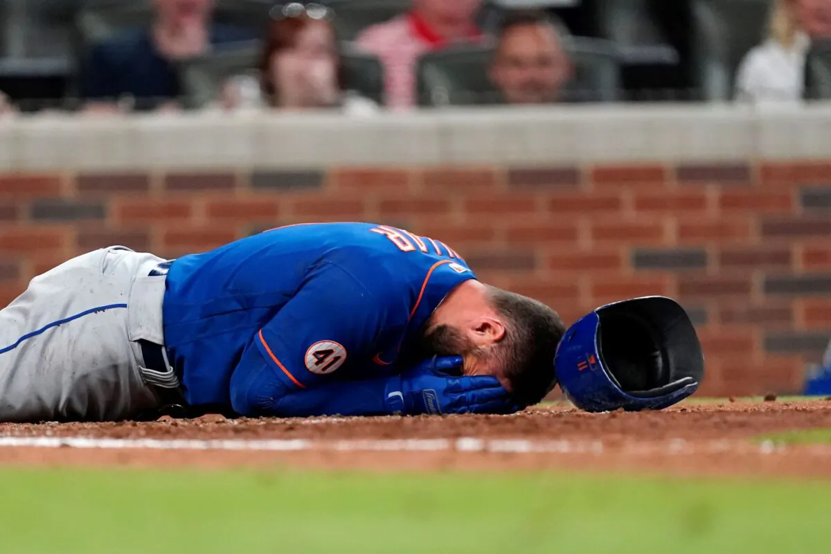 New York Mets' Kevin Pillar lies on the ground after being hit in the face with a pitch from Atlanta Braves pitcher Jacob Webb in the seventh inning of a baseball game in Atlanta, Ga., on May 17, 2021. (John Bazemore/AP Photo)