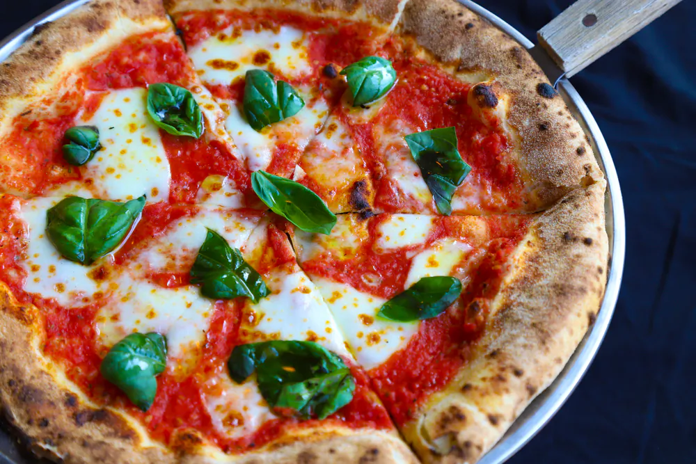 There's nothing like the taste of fresh tomatoes, fresh basil, and freshly grated Parmesan cheese on this freshly baked no-rise homemade dough. (Sea Salt/Shutterstock)