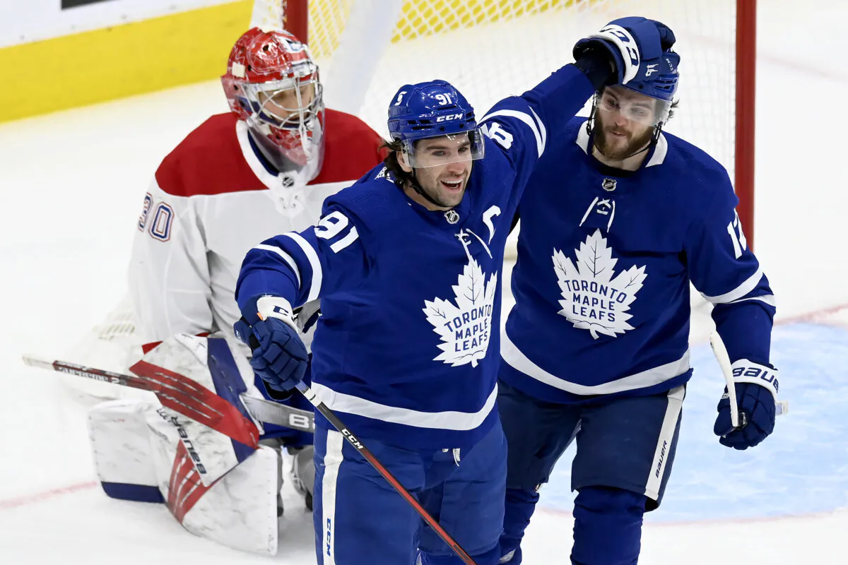 Toronto Maple Leafs center John Tavares (91) celebrates his goal with Alex Galchenyuk (12), in front of Montreal Canadiens goaltender Cayden Primeau (30) during the first period of an NHL hockey game in Toronto, Canada, on May, 6, 2021. (Frank Gunn/The Canadian Press via AP)