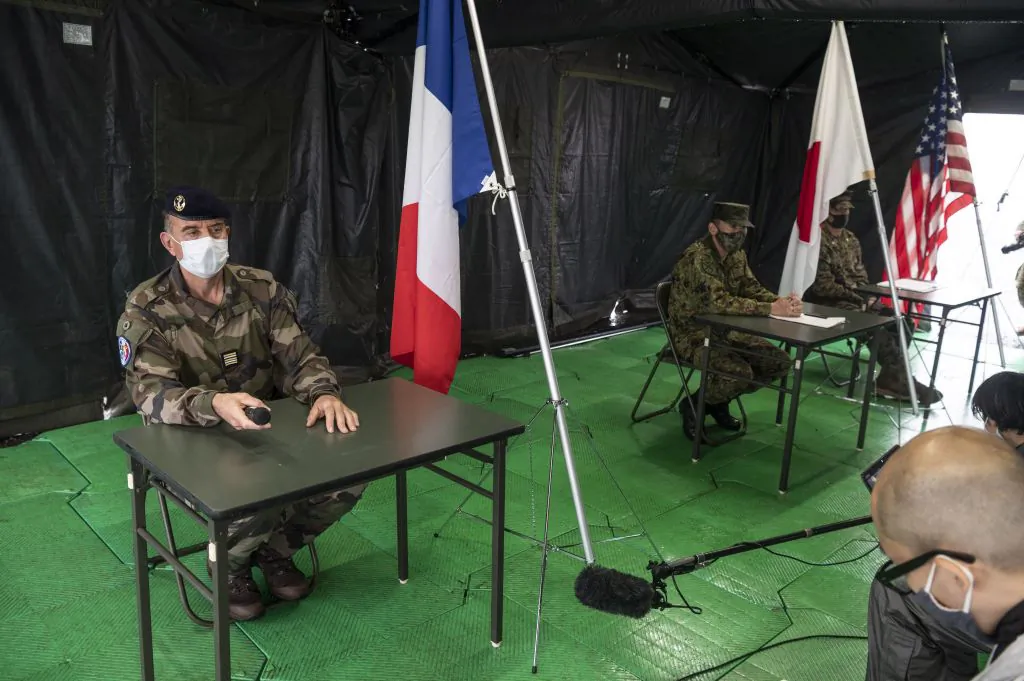 French Army lieutnant colonel Henri Marcaillou (L), Japan Self-Defense Force colonel Masashi Hiraki (C), and U.S. Marines lieutnant colonel Jeremy Nielson (R) attend a joint military drill between the Japan Self-Defense Force, the French Army, and U.S. Marines at the Kirishima exercise area in Ebino, Miyazaki Prefecture, on May 15, 2021. (Charly Triballeau/ AFP via Getty Images)