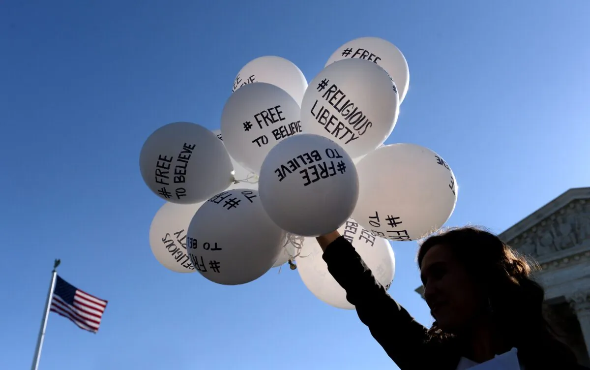 A protester holds balloons calling for religious freedom, outside the U.S. Supreme Court in Washington on April 28, 2015. (Olivier Douliery/Getty Images)