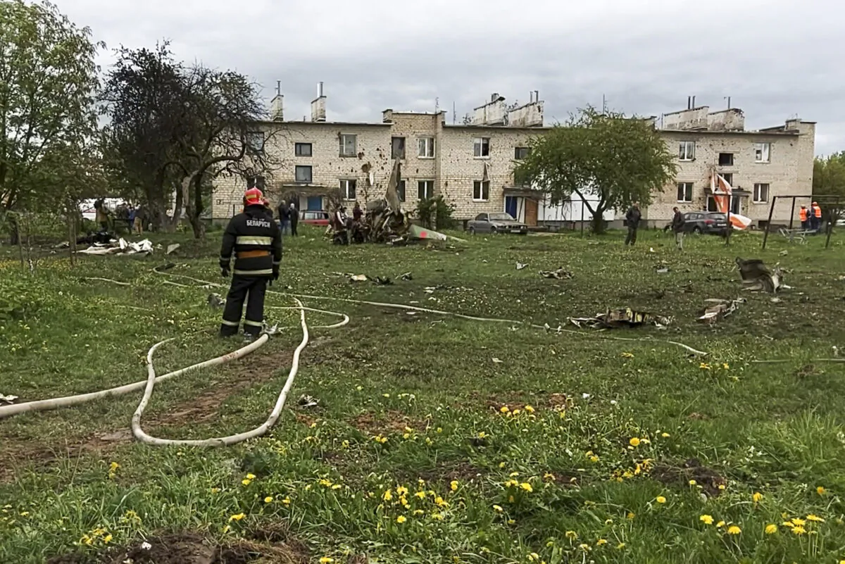 A firefighter stands at the scene of crashes Belarusian military Russian-built Yak-130 trainer jet in Baranovichi, Belarus, on May 19, 2021. (Vadim Yakubenko, BetTA photo via AP)