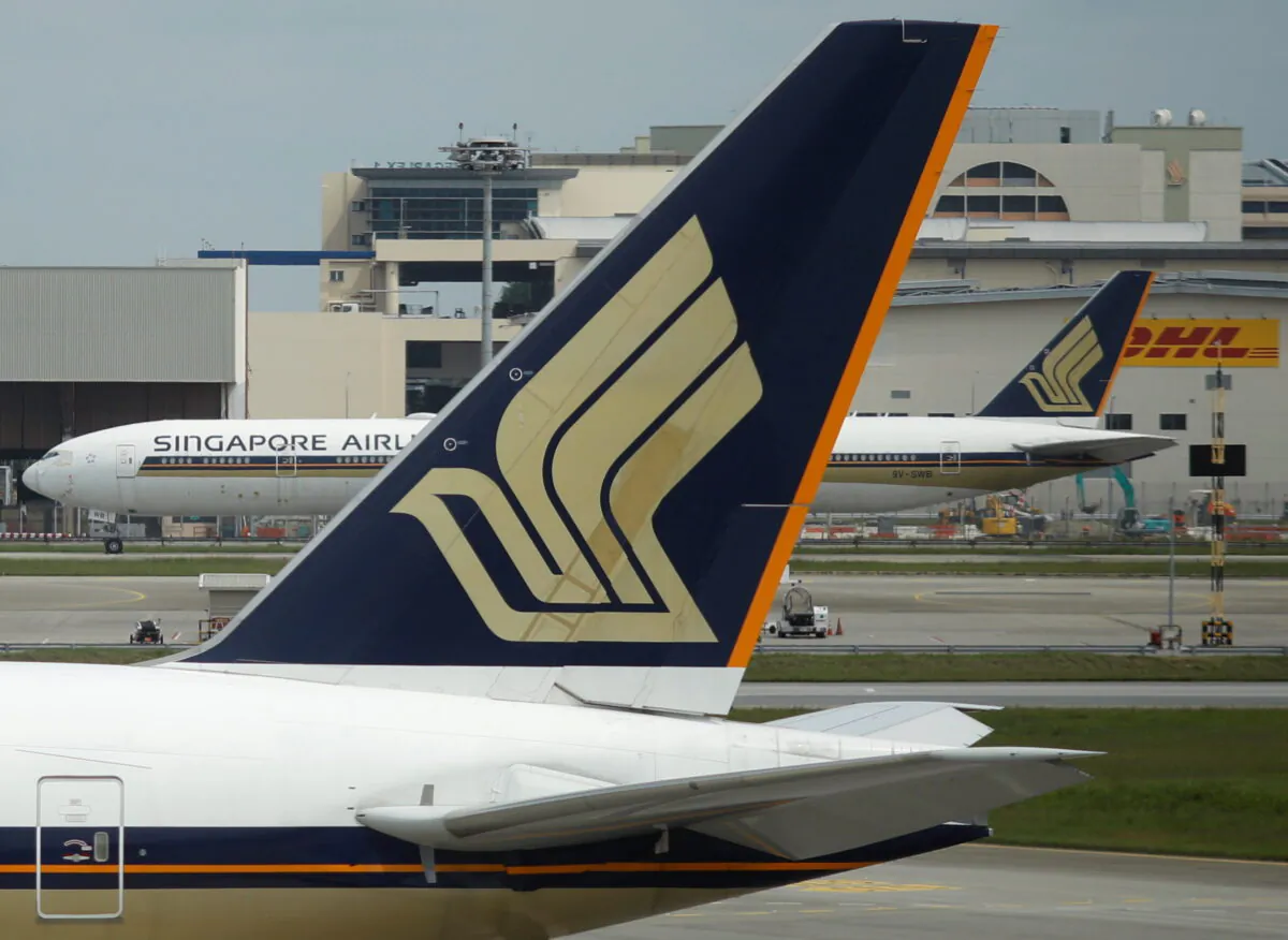 Singapore Airlines planes sit on the tarmac at Changi Airport in Singapore, on Dec. 8, 2020. (Edgar Su/Reuters)