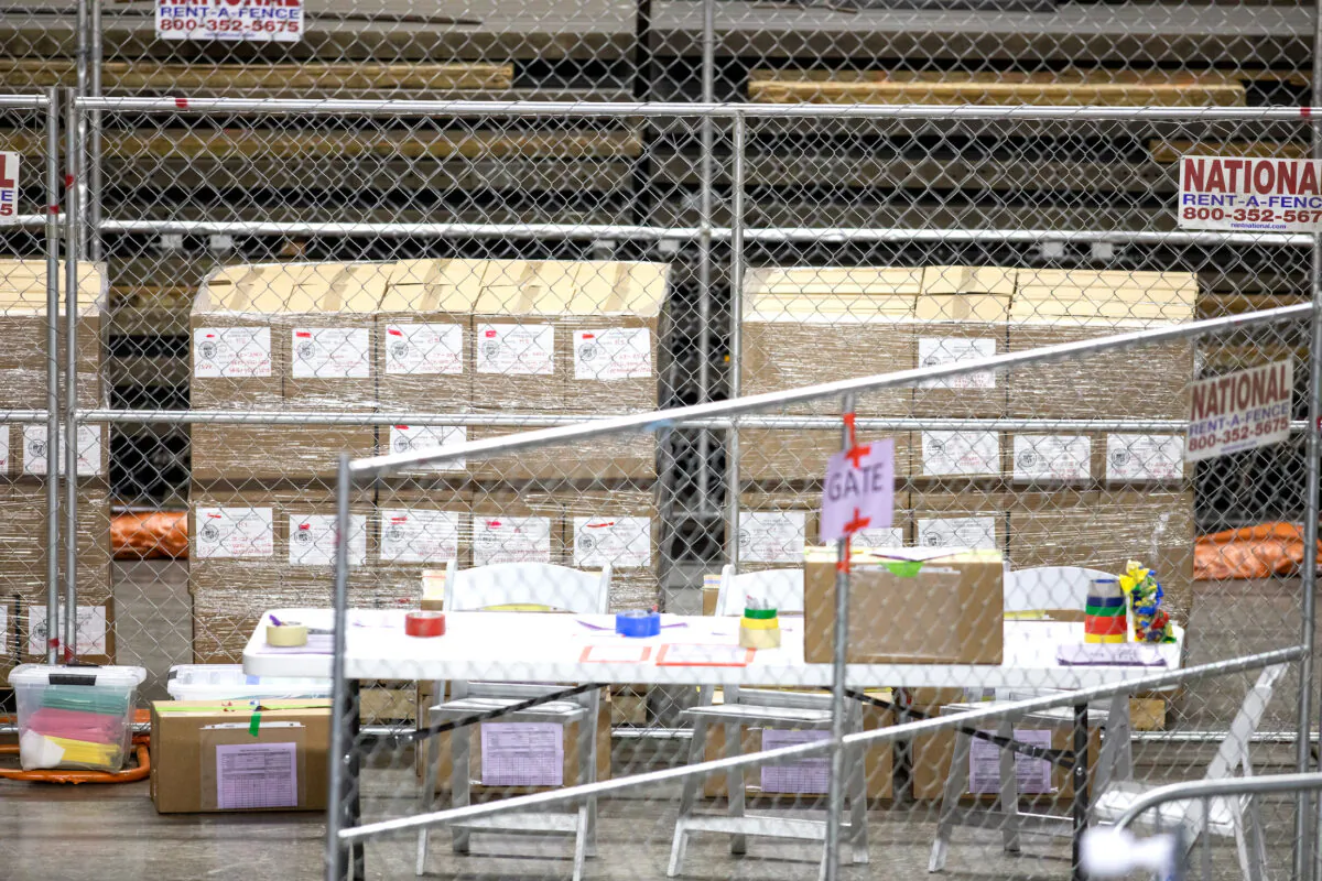 Ballots from the 2020 general election wait to be counted at Veterans Memorial Coliseum on May 1, 2021 in Phoenix, Ariz., where the Electronic Registration Information Center (ERIC) uncovered more than 200,000 voters that had either moved or died before the 2022 midterms. (Courtney Pedroza/Getty Images)