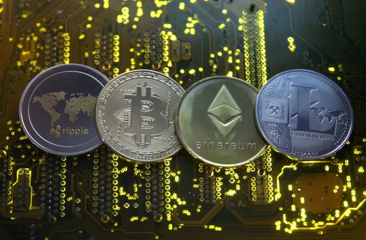 Representations of the Ripple, bitcoin, etherum, and Litecoin virtual currencies are seen on a PC motherboard in this illustration picture, on Feb. 14, 2018. (Dado Ruvic/Reuters)