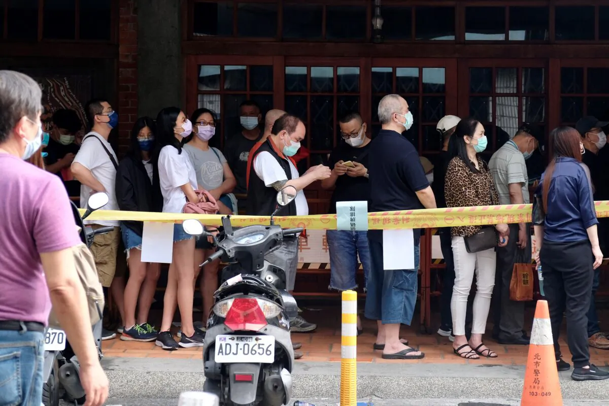 Local residents line up for the COVID-19 testing at the Wanhua District in Taipei, Taiwan on May 19, 2021. (Sam Yeh/AFP via Getty Images)