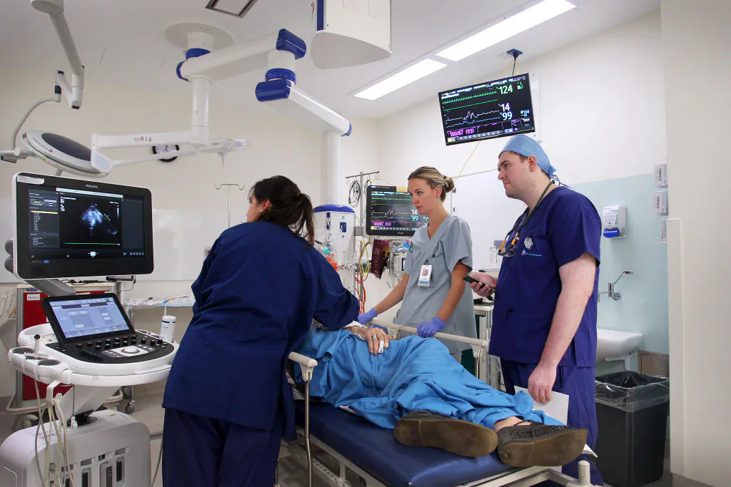 Emergency medical staff and Callum Cherrett Cardiology AT (C) treat a patient with suspected heart issues in the Emergency Department of St Vincent's Hospital in Sydney, Australia, on June 4, 2020. (Lisa Maree Williams/Getty Images)