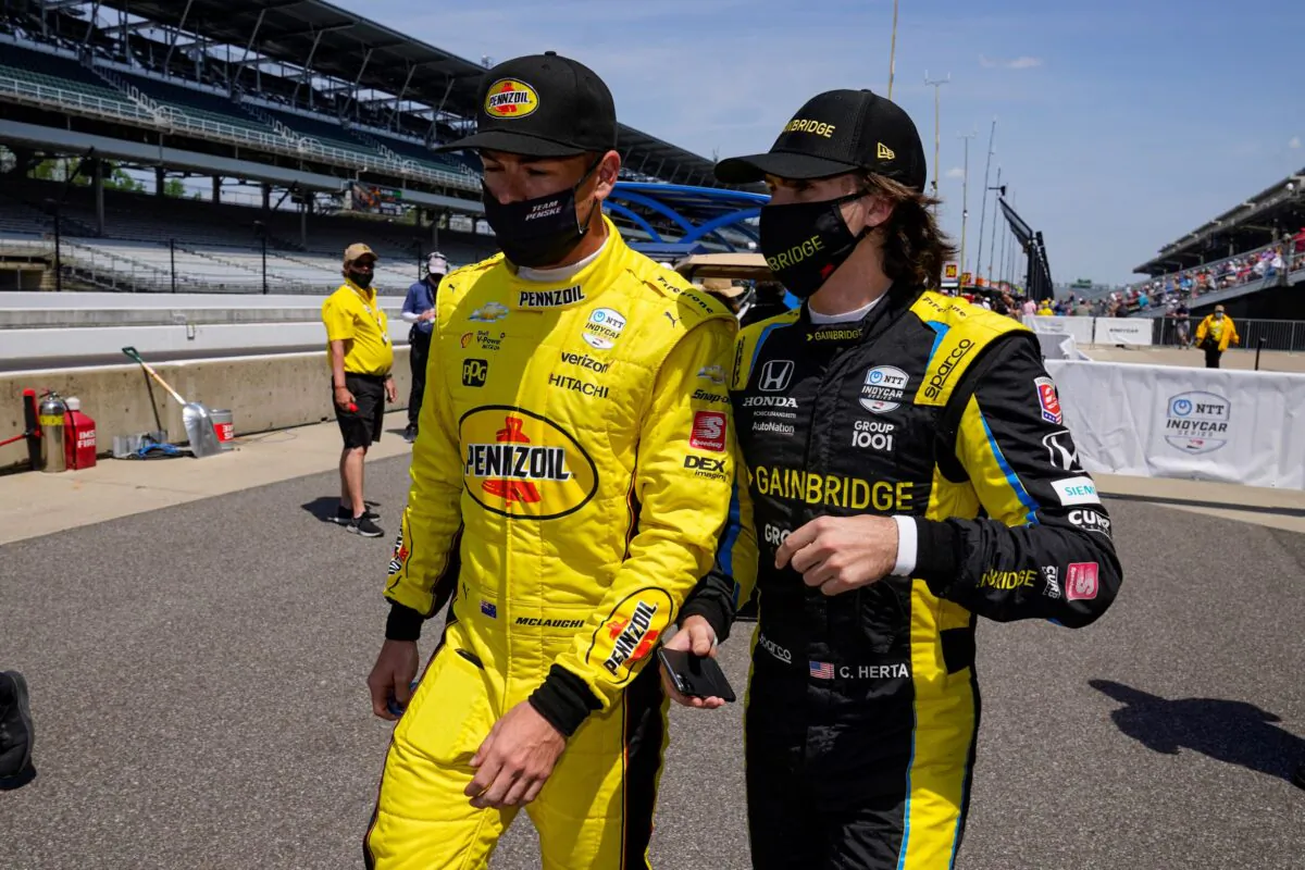 Scott McLaughlin, left, of New Zealand, and Colton Herta walk out of the pit area during practice for the Indianapolis 500 auto race at Indianapolis Motor Speedway in Indianapolis on Thursday, May 20, 2021. (Michael Conroy/AP Photo/)