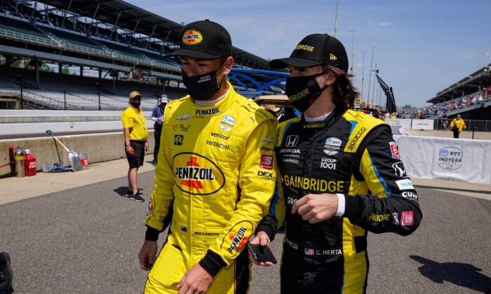 Scott McLaughlin, left, of New Zealand, and Colton Herta walk out of the pit area during practice for the Indianapolis 500 auto race at Indianapolis Motor Speedway in Indianapolis on Thursday, May 20, 2021. (Michael Conroy/AP Photo/)