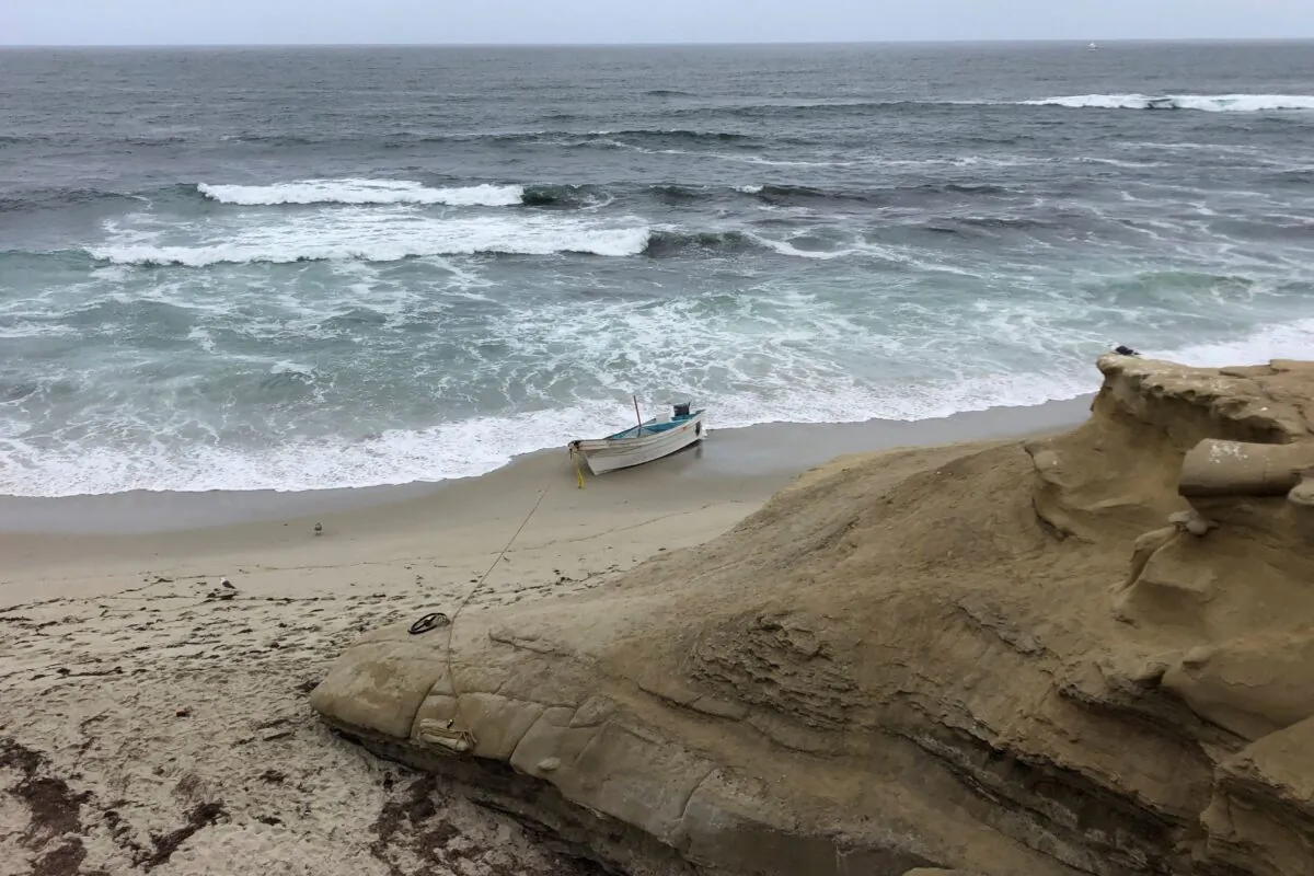 A small boat used during a suspected human smuggling operation sits on La Jolla beach in San Diego, Calif., on Thursday, May 20, 2021. (Gregory Bull/AP Photo)