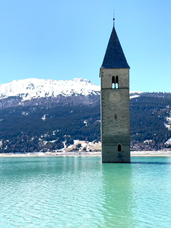 church bell tower emerging from a lake