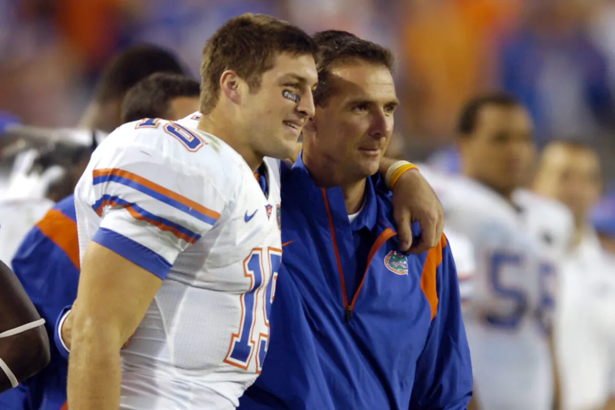 Florida quarterback Tim Tebow (L) and coach Urban Meyer celebrate in the fourth quarter during an NCAA college football game against Georgia in Jacksonville, Fla., on Nov. 1, 2008. (Stephen Morton/AP Photo)