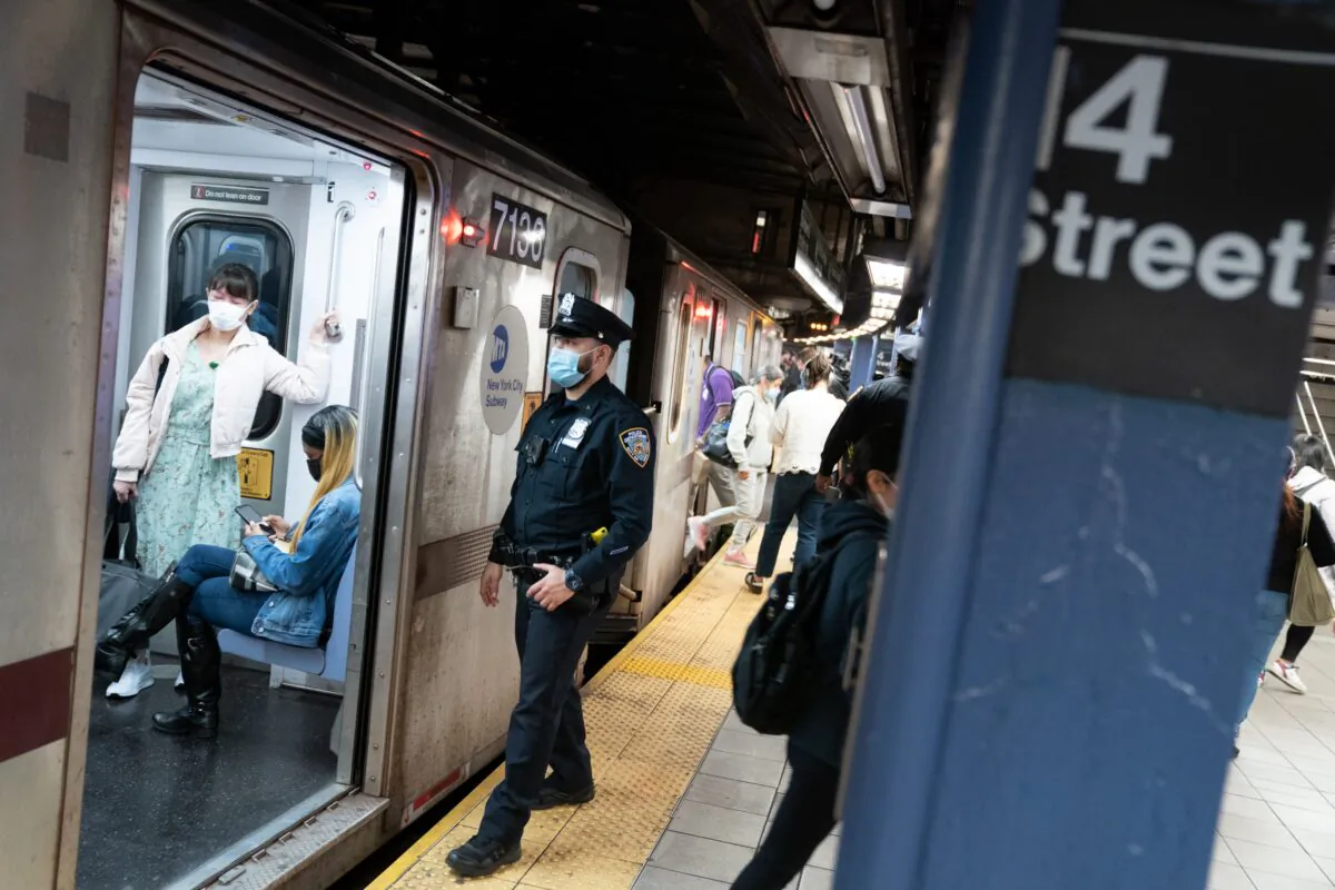 An NYPD officer checks a subway train as it pulls into Union Square subway station in Manhattan, New York City, on May 14, 2021. (Barry Williams/New York Daily News/TNS)
