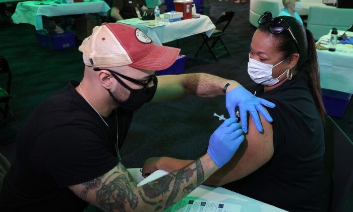 Tina Lopez receives her first dose of the COVID-19 vaccine prior to a game between the Milwaukee Bucks and the Brooklyn Nets at Fiserv Forum in Milwaukee, Wis., on May 2, 2021. (Stacy Revere/Getty Images)
