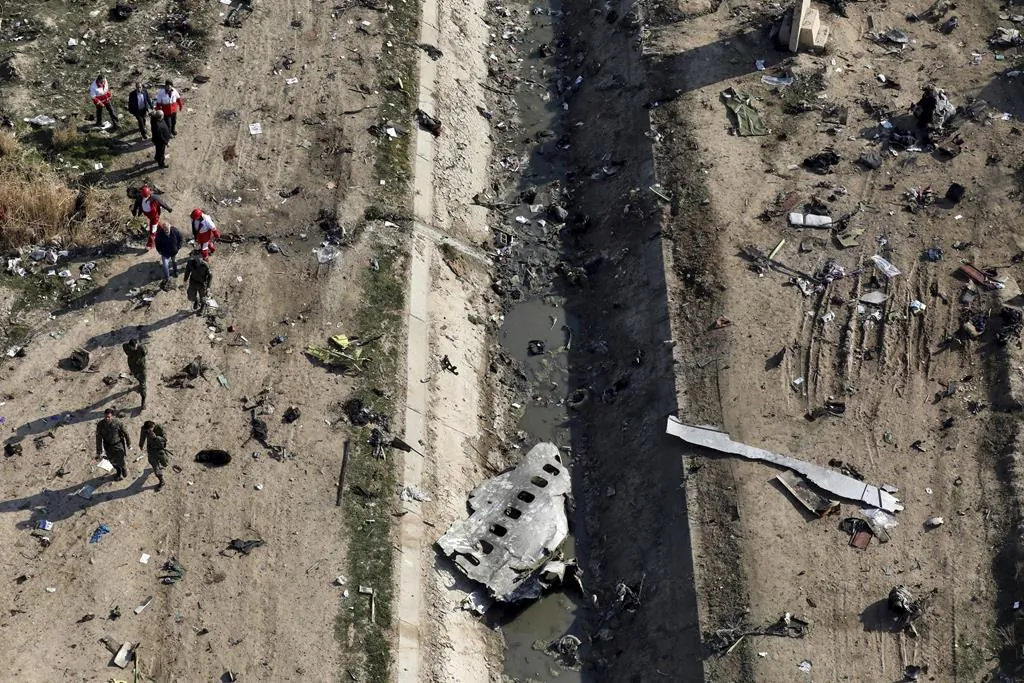 Rescue workers search the scene where a Ukrainian plane crashed in Shahedshahr, southwest of the capital Tehran, Iran, on Jan. 8, 2020. An Ontario court has ruled that the Iranian military’s downing of a passenger jet early last year was an intentional act of terrorism, paving the way for relatives of those killed to seek compensation from the country. (The Canadian Press/AP-Ebrahim Noroozi)