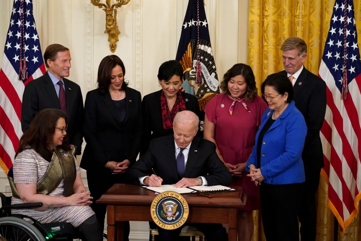 President Joe Biden signs the COVID-19 Hate Crimes Act into law during a ceremony in the East Room at the White House in Washington, on May 20, 2021. (Kevin Lamarque/Reuters)