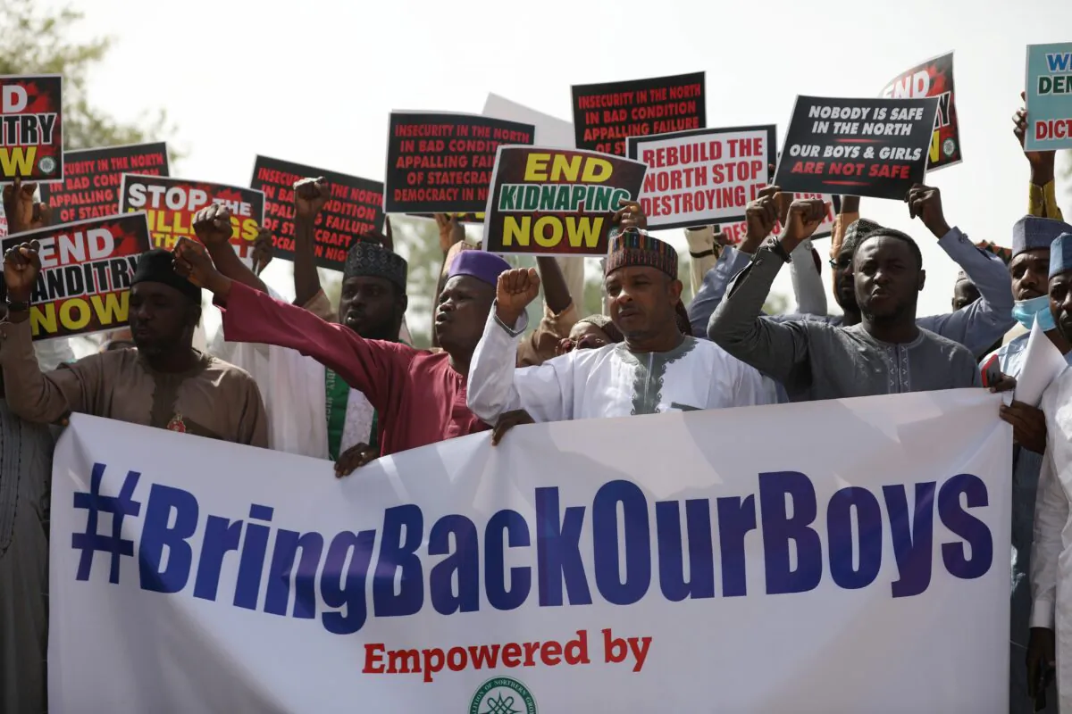 Supporters of the Coalition of Northern Groups (CNG) rally to urge authorities to rescue hundreds of schoolboys abducted by Boko Haram affiliated gangs, in northwestern state of Katsina, Nigeria on Dec. 17, 2020. (Kola Sulaimon/AFP via Getty Images)
