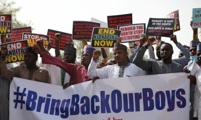 Supporters of the Coalition of Northern Groups (CNG) rally to urge authorities to rescue hundreds of schoolboys abducted by Boko Haram affiliated gangs, in northwestern state of Katsina, Nigeria on Dec. 17, 2020. (Kola Sulaimon/AFP via Getty Images)