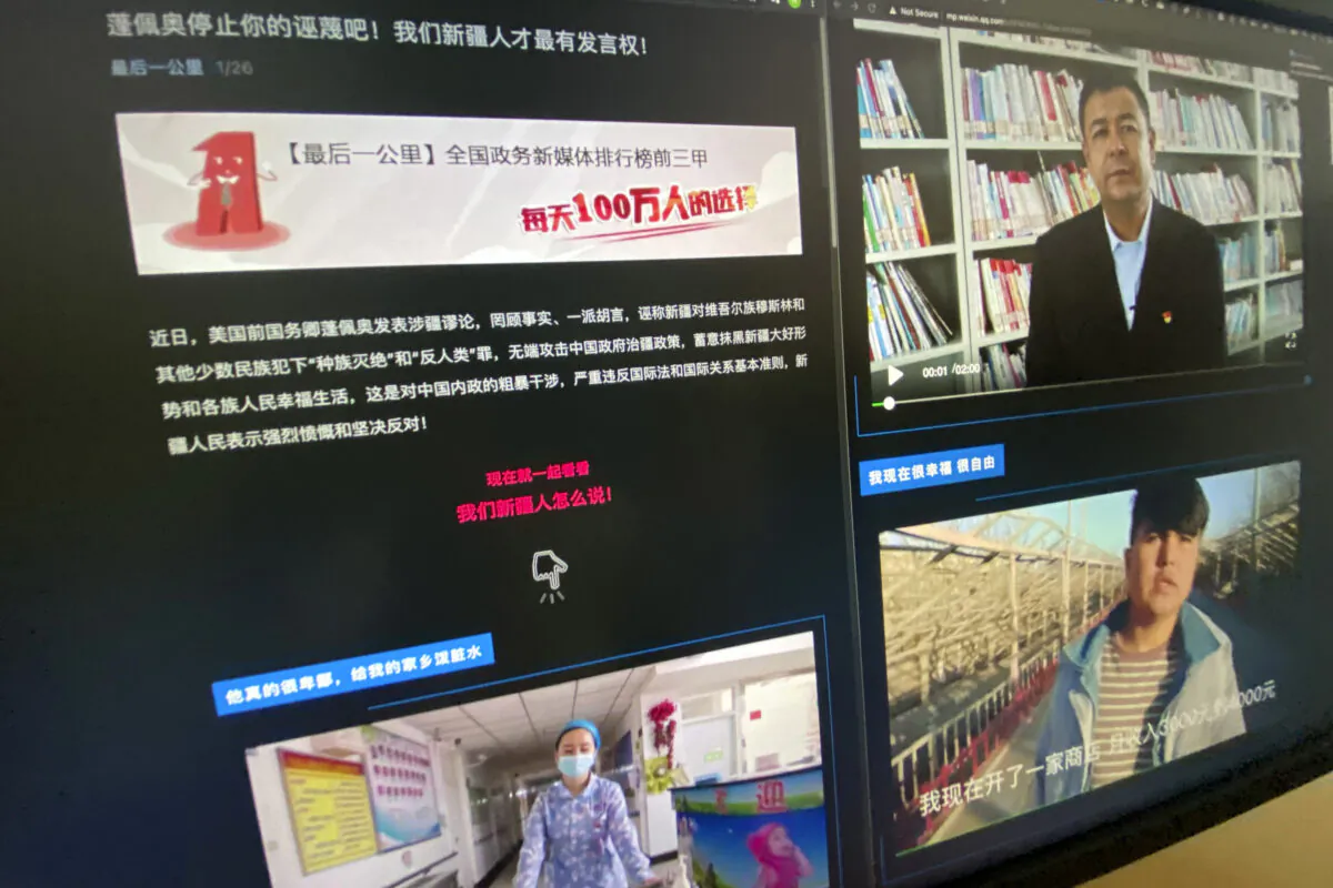 A webpage with the title "Pompeo stop your slanders! Only We Xinjiang people have a say!" and videos of ethnic Uyghurs responding to former U.S. Secretary of State Mike Pompeo is seen on a computer screen in Beijing on May 19, 2021. (Ng Han Gua/AP Photo)