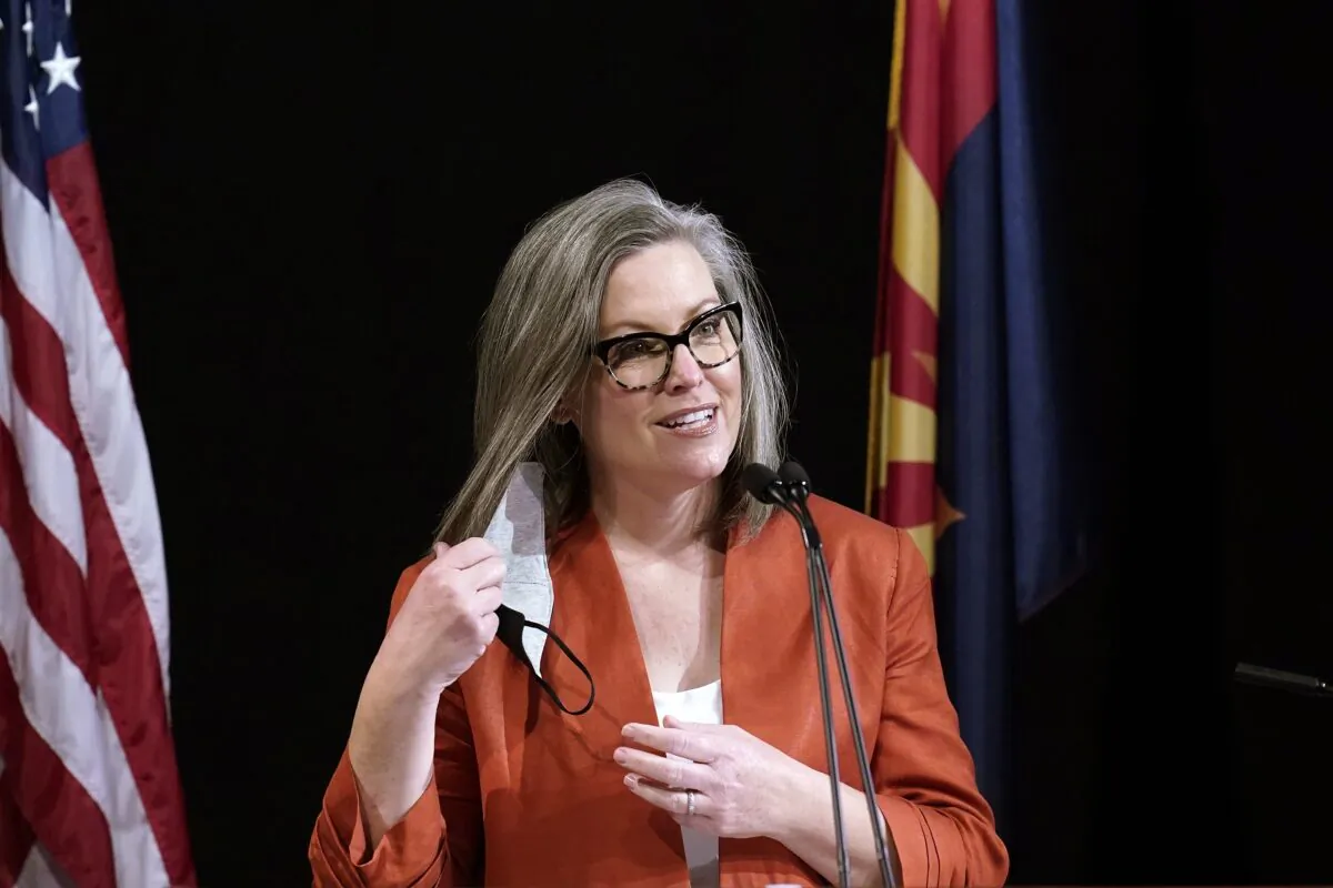 Arizona Secretary of State Katie Hobbs removes a mask as she speaks to members of Arizona's Electoral College prior to them casting their votes in Phoenix, Ariz., on Dec. 14, 2020. (Ross D. Franklin/AP Photo)