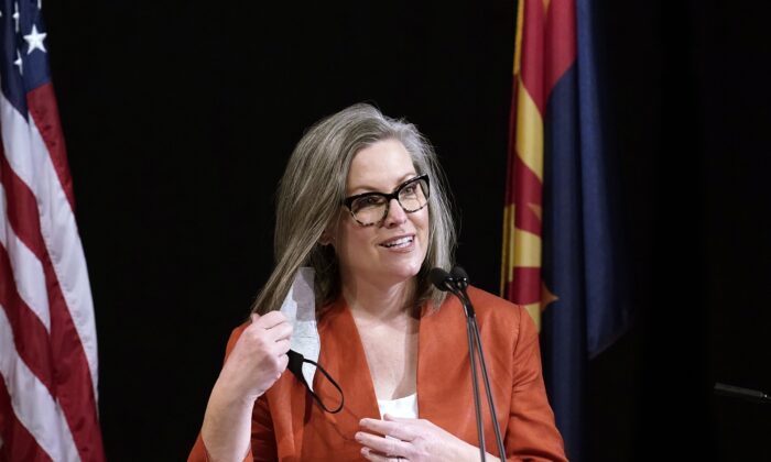 Arizona Secretary of State Katie Hobbs removes a mask as she speaks to members of Arizona's Electoral College prior to them casting their votes in Phoenix, Ariz., on Dec. 14, 2020. (Ross D. Franklin/AP Photo)