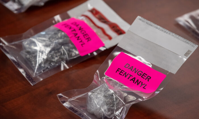 Bags containing fentanyl are displayed as evidence during a news conference at the Surrey RCMP headquarters in Surrey, B.C., on Sept. 3, 2020. A search warrant executed at a residence yielded a seizure that included 3.1 kilograms of fentanyl, more than $100,000 in cash, and a drug brick press. (Darryl Dyck/The Canadian Press)