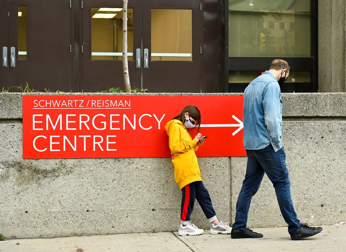 People wait in line for hours at a COVID assessment centre in Toronto on Sept. 24, 2020. (The Canadian Press/Nathan Denette)