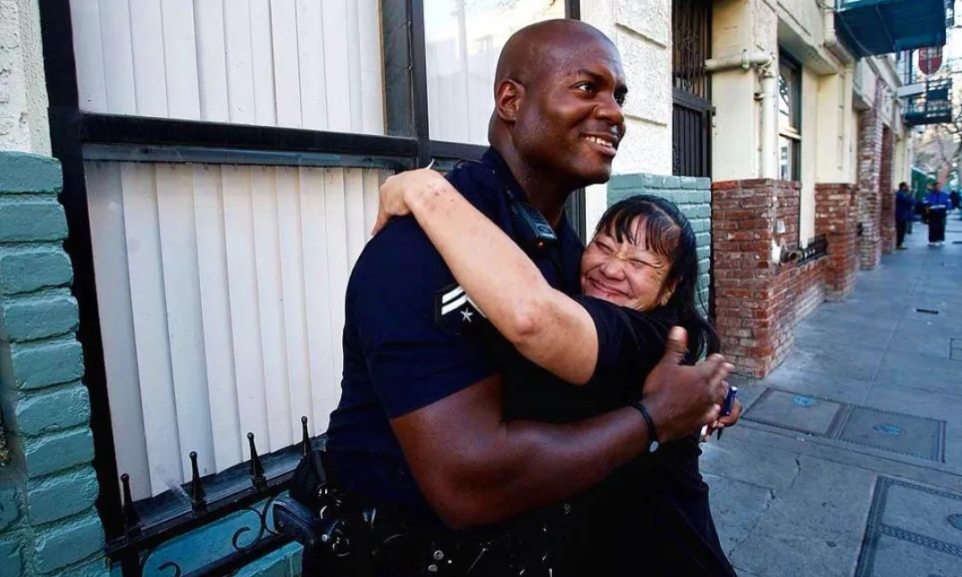 Officer Deon Joseph of the Los Angeles Police Department hugs a resident of Skid Row in downtown Los Angeles. (Courtesy of Deon Joseph)