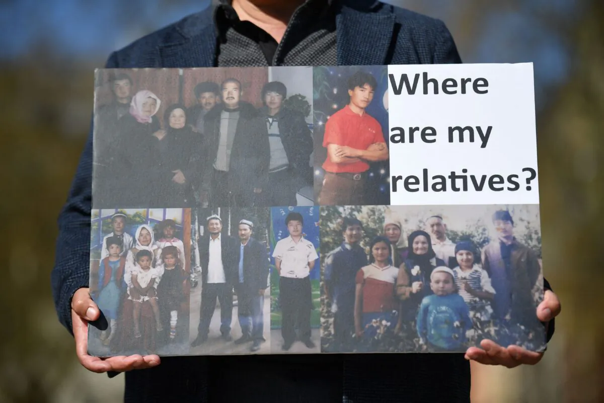 A member of the Uyghur community holds a placard as he joins a demonstration to call on the British parliament to vote to recognize alleged persecution of China's Muslim minority Uyghur people as genocide and crimes against humanity in London on April 22, 2021. (Justin Tallis/AFP via Getty Images)